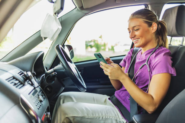 istock A young Caucasian female doctor is using her smart phone while in the car. 1410068047