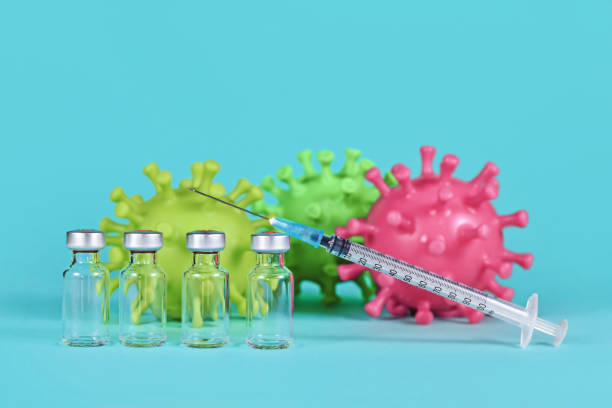 istock 4 vaccine vials with syringes and corona virus 1410068758