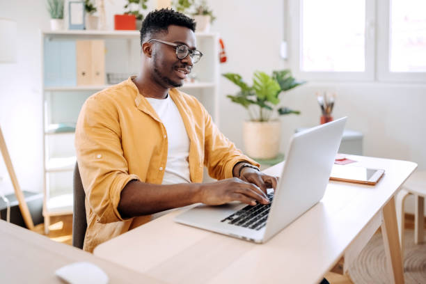 istock Young casually clothed businessman working from home office 1410069355
