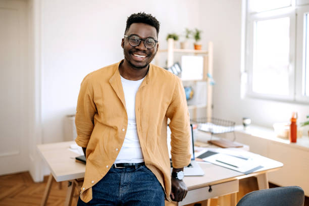 istock Young casually clothed businessman posing in his home office setup 1410070289