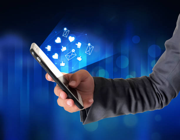 istock Man using social media with glowing notifications and signs on screen 1410070291