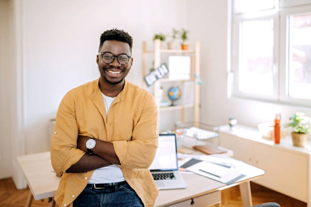 istock Young casually clothed businessman posing in his home office setup 1410070306