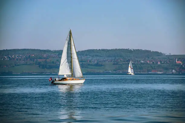 Sailboats sail on the blue lake