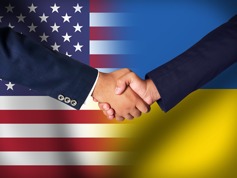 America and Ukraine friendship concept background with handshake. Business and support agreement backdrop
