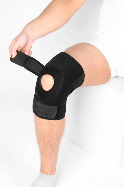 istock Knee Support Brace on leg isolated on white background. Elastic orthopedic orthosis. Anatomic braces for knee fixation, injuries and pain. Protective knee joint bandage sleeve. Trauma, rehabilitation 1410073593