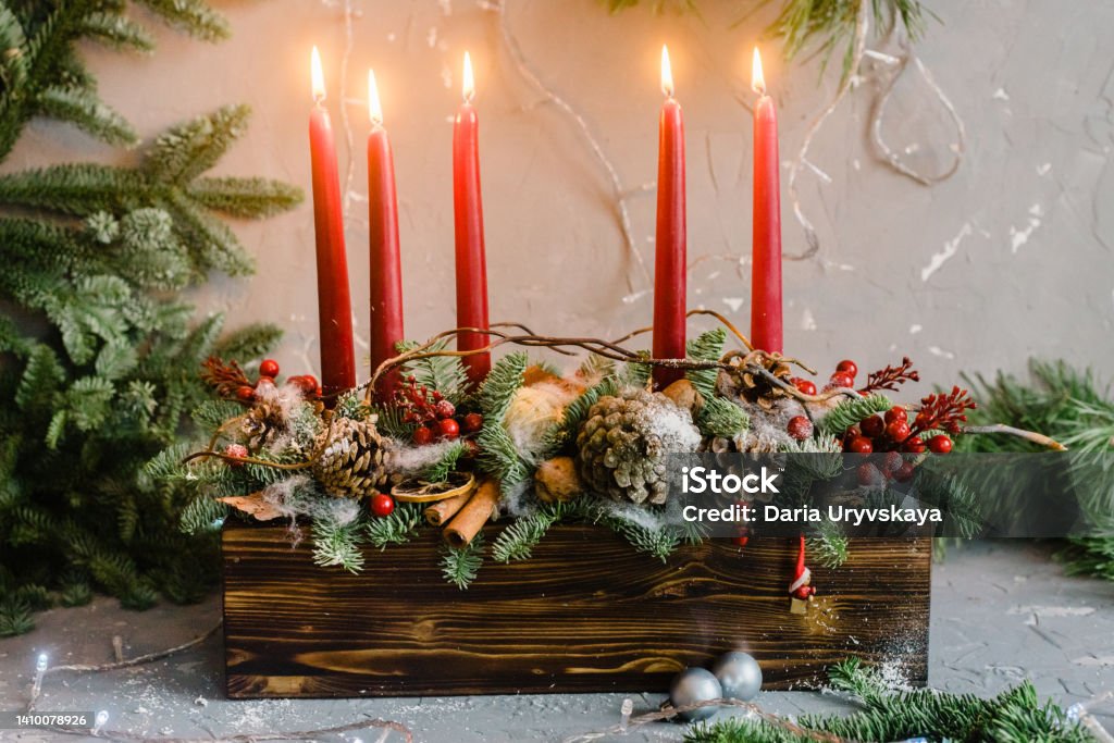Decorative christmas composition with five red candles and pine Centerpiece Stock Photo