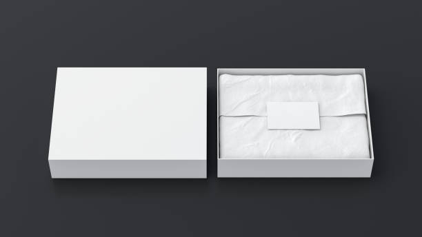 istock Gift box mock up with cover. White gift box with blank label or business card on wrapping paper. Black background. Front view. 1410078994