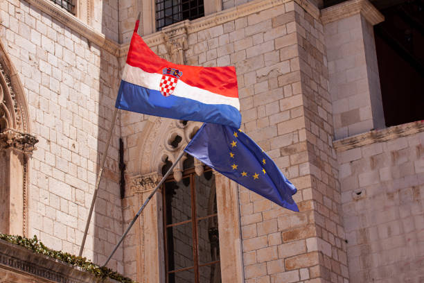 istock Croatian and EU European Union flags waving from building 1410079006