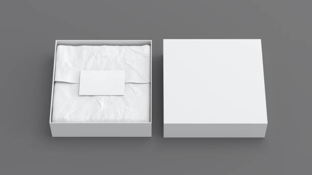 istock Square gift box mock up. White gift box with blank label or business card on wrapping paper. Gray background. Front view. 1410079552