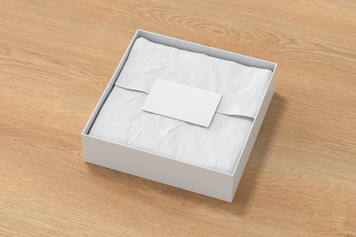 Square gift box mock up. White gift box with blank label or business card on wrapping paper. Wooden background. Side view. 3d illustration