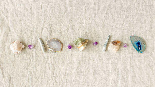 istock Top view different crystals and stones in row on table, healing minerals agate, quartz, amethyst, onyx. Stones for crystal therapy. Flat lay semiprecious gems, alternative medicine concept, copyspace 1410080459