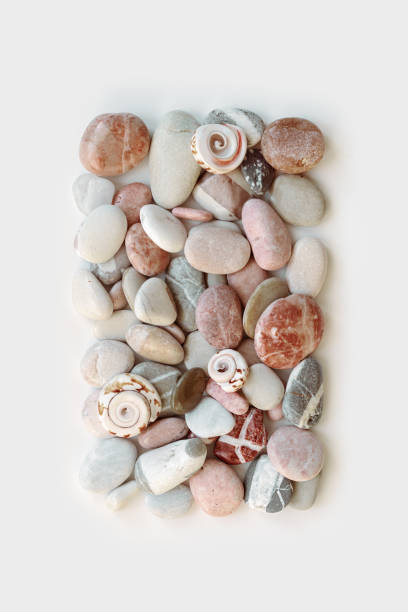 istock Aesthetic minimal pattern with set of sea pebble stones on white background. Square composition from natural round smooth stone pink grey color. Collection of rocks, summer concept, top view 1410080462