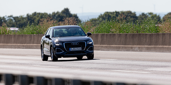 Frankfurt am Main, Hesse, Germany, july 17th 2022, close-up of a German black Audi Q2 SUV approaching on German Autobahn A3 near Frankfurt am Main, the Q2-series is produced by German automaker Audi AG since 2016