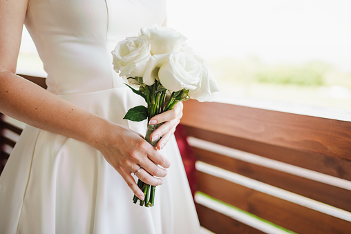 Bride and her white roses wedding bouquet