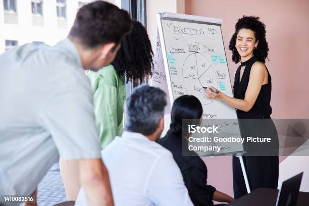 Young Businesswoman Laughing During A Presentation To Colleagues In A Boardroom Stock Photo - Download Image Now