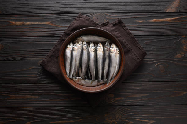 sardine fresche su fondo rustico in legno. - cracking the code foto e immagini stock