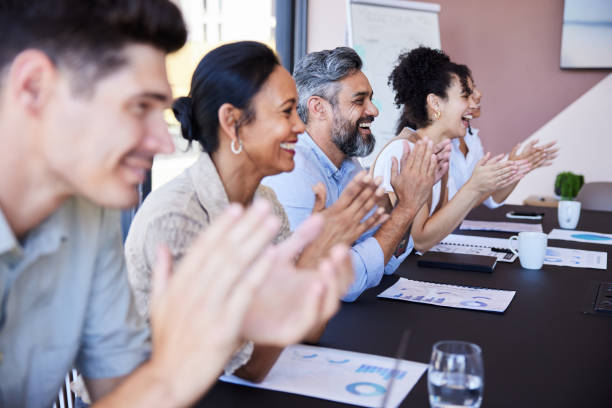 istock Smiling businesspeople clapping after a presentation in an office boardroom 1410084246