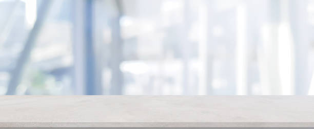 istock Abstract blurred blue color of interior modern office room background with perspective cement quartz table for show, promote and design content or product on display concept 1410086107