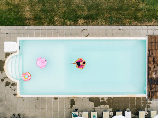 istock A man is relaxing in a swimming pool, sitting on an inflatable donut 1410086174