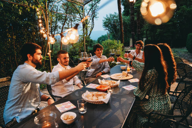 istock Friends toasting together at dinner 1410086290
