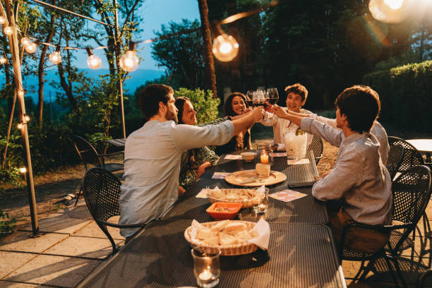 istock Friends toasting together at dinner 1410086299