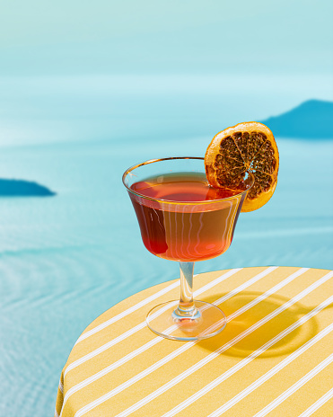 Glass of delicious refreshing cocktail isolated over beautiful sea landscape background. Vacation. Concept of cocktails, alcoholic drinks, taste, party, mix. Copy space for ad. Retro style