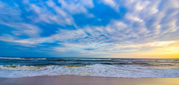 Waves from the Gulf of Mexico gently washing over the sand, New Year's Day, walk on the beach at sunset, Alabama Point in Orange Beach, Alabama