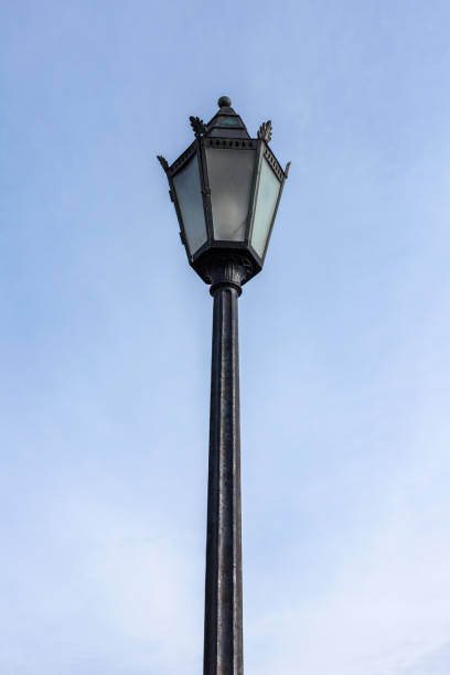 istock Vintage forged street lamp is under blue sky 1410089266