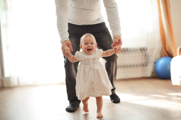 istock Father and his daughter child girl first step 1410089321