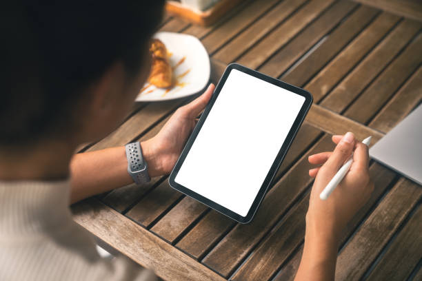 istock close-up women holding digital tablet white screen and stylus pe 1410090298
