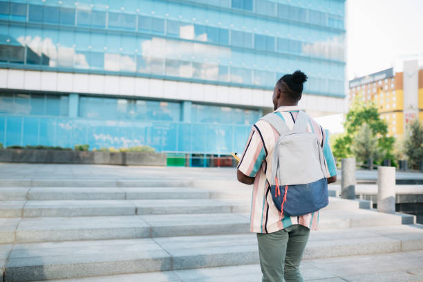 istock Young adult university student going to class 1410092192