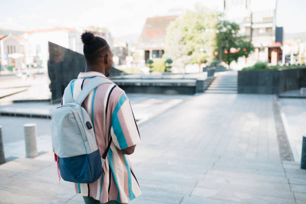 istock Young adult university student going to class 1410092212
