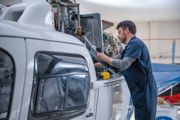 istock Male mechanic checking helicopter 1410092754