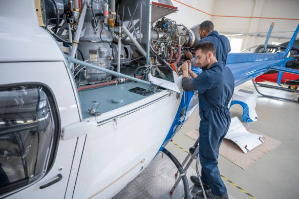 istock Mechanics repairing helicopter engine 1410092825