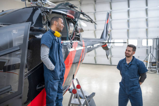istock Male mechanics standing near helicopter 1410092830