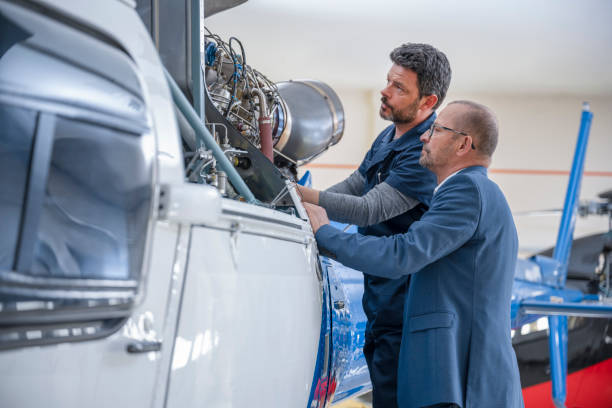 istock Mechanics repairing helicopter engine 1410092836
