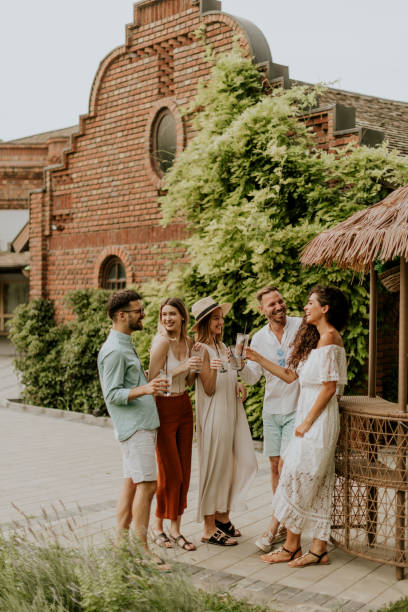 istock Group of young people cheering and having fun outdoors with drinks 1410092972