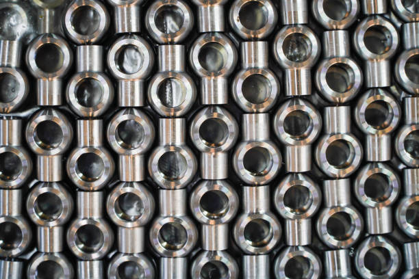 Shiny steel parts background. Regular industrial metal production pattern with selective focus.High precision steel automotive parts manufacturing by innovative CNC machining