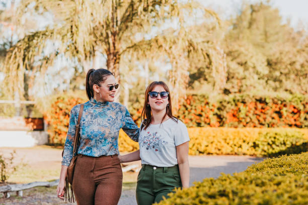 istock Lesbian couple walking in the courtyard chatting hugging and smiling 1410094875