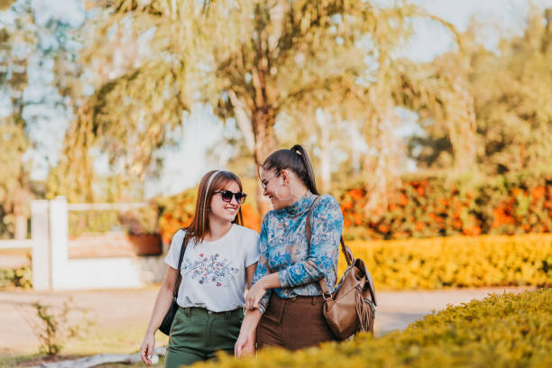 istock Lesbian couple walking in the courtyard chatting hugging and smiling 1410095345