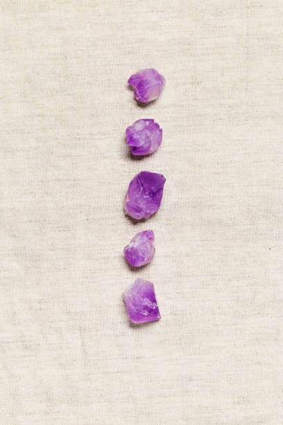 istock Flat lay from purple amethyst crystals on textile background with copy space,  top view natural beautiful gemstone. Amethyst stone healing crystal, rocks quartz mineral close up 1410095398