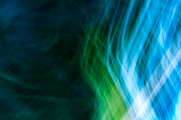 Abstraction, small bright luminous thin lines from top to bottom, blue-green shades with a gradient. Backdrop