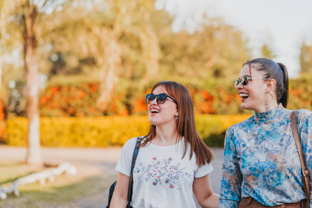 istock Lesbian couple walking in the courtyard chatting hugging and smiling 1410096545