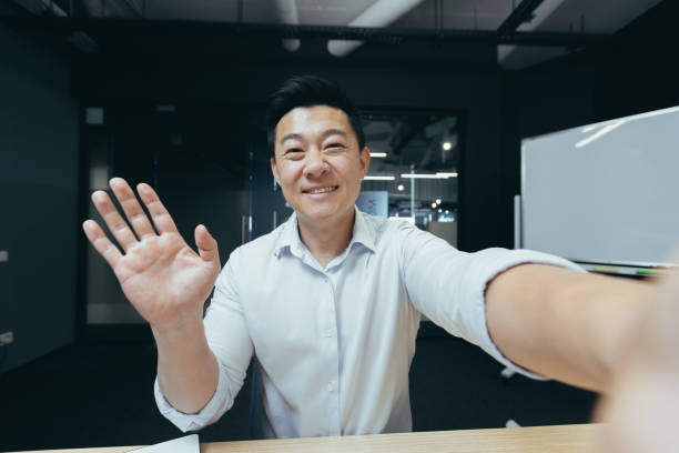 istock Asian businessman working in modern office, successful man talking on video phone call 1410097257