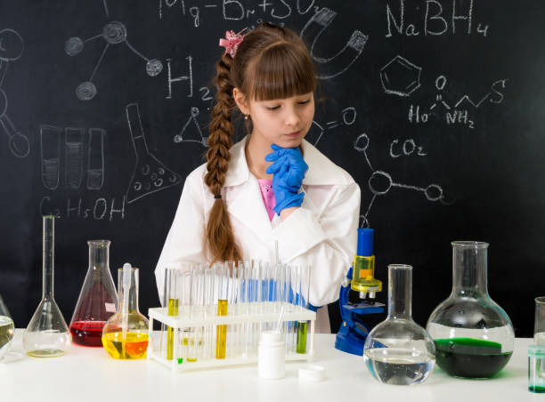 istock little smarl girl in chemistry lab doing an experiment 1410097408