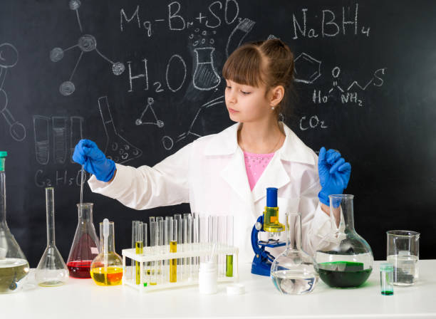 istock little smarl girl in chemistry lab doing an experiment 1410097420