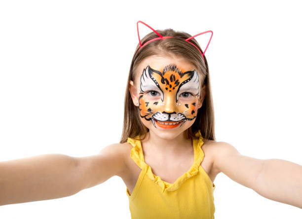 istock lovely little girl with painted face making selfie 1410098971