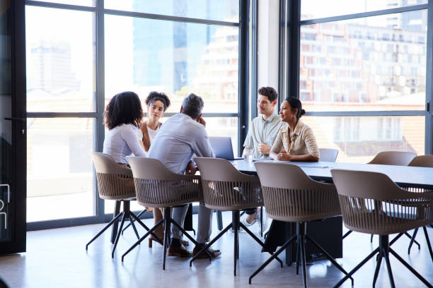istock Businesspeople having a meeting together around a boardroom table 1410099234