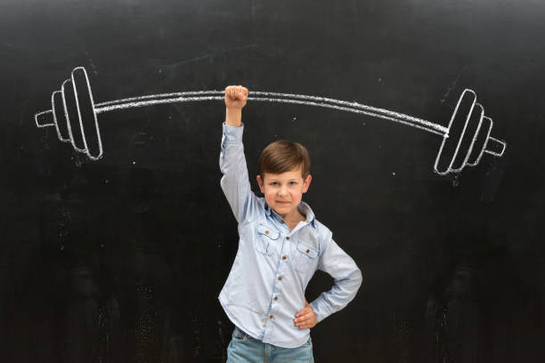 istock cute little boy rising drawn barbell on finger 1410100266