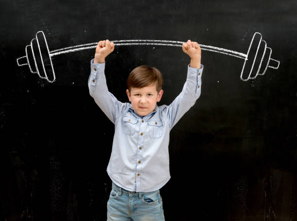 istock funny little boy rising up drawn heavy barbell 1410100269